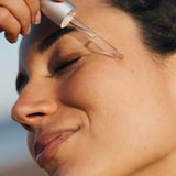 Zenicure REJUVENATING FACIAL OIL dropper on face