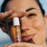 Woman holding Carry Om STRESS-RELIEVING AROMATHERAPY ESSENCE