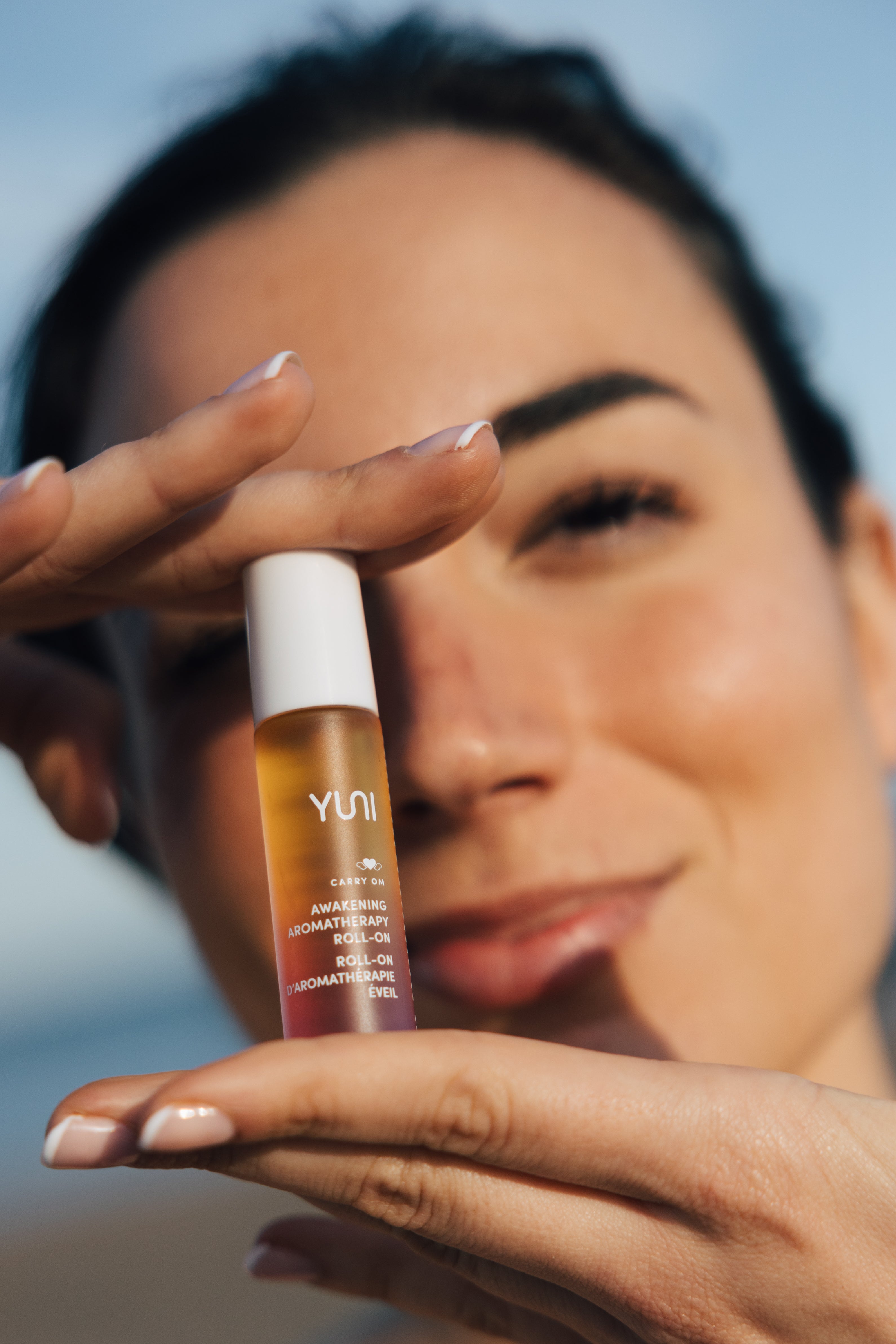 Woman holding Carry Om STRESS-RELIEVING AROMATHERAPY ESSENCE