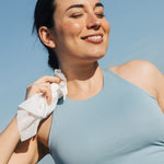 Woman using shower sheet wipe on neck