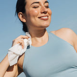 Woman using shower sheet wipe on neck