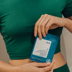 Woman holding shower sheets wipe