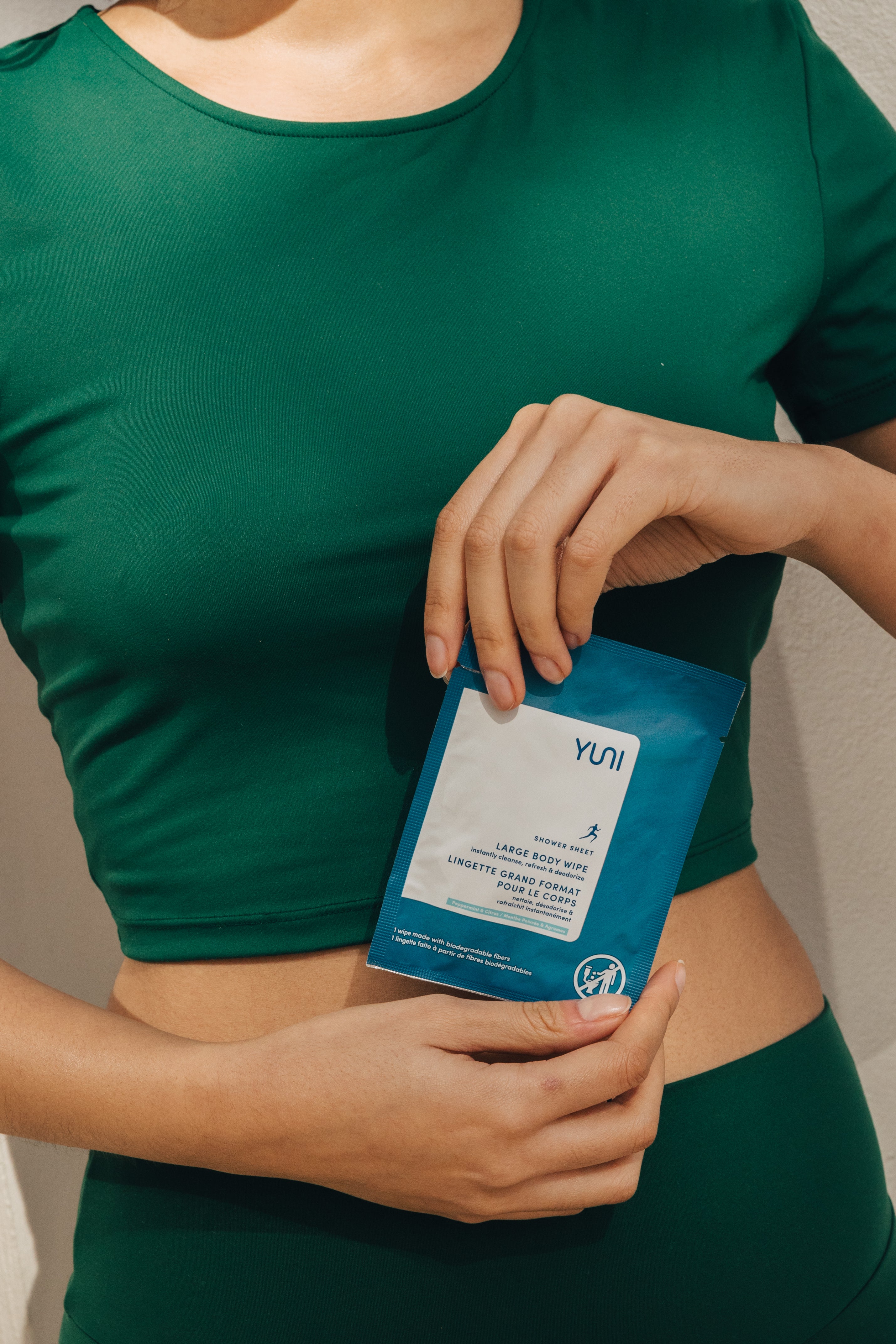 Woman holding shower sheets wipe